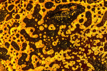 Abstract gold background, gold drops on black background, gold splashing and bubbling