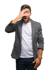 Young handsome business man over isolated background peeking in shock covering face and eyes with hand, looking through fingers with embarrassed expression.