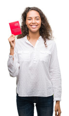 Young hispanic woman holding passport of Switzerland with a happy face standing and smiling with a confident smile showing teeth