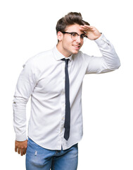Young business man wearing glasses over isolated background very happy and smiling looking far away with hand over head. Searching concept.