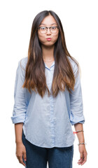 Young asian business woman wearing glasses over isolated background puffing cheeks with funny face. Mouth inflated with air, crazy expression.