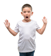 Dark haired little child scared in shock with a surprise face, afraid and excited with fear...