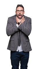 Young handsome business man over isolated background shouting and suffocate because painful strangle. Health problem. Asphyxiate and suicide concept.