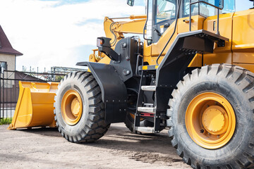 Yellow tractor at the back. Construction equipment.