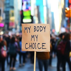 Protesters gather in a city street holding a banner advocating for body autonomy and choice