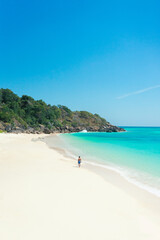 Tourist on a tropical beach with blue water. summer background and summer holiday concept.