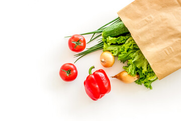 Buying fresh vegetables in paper bag on white background top vie