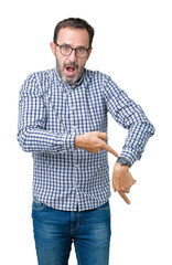 Handsome middle age elegant senior man wearing glasses over isolated background In hurry pointing...