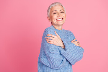 Photo portrait of pretty retired female hugging self enjoy warmth wear trendy blue knitwear outfit...