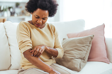 Woman Examining Her Elbow for Skin Irritation at Home