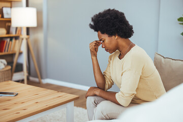 Stressed Woman Sitting at Home Feeling Anxious and Overwhelmed