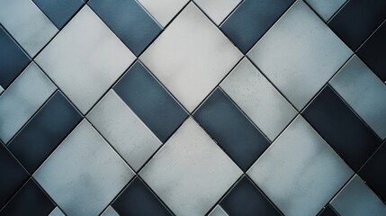 Abstract close-up of a geometric, tiled wall with alternating light and dark squares creating a striking visual pattern.