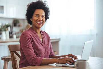 Confident Woman Working on Laptop in Modern Home Office