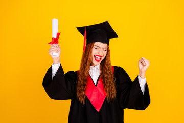 Photo of glad charming girl graduate wear black mantle complete college isolated on yellow color...