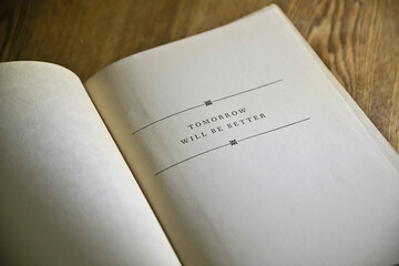 Open book with the quote “Tomorrow will be better”