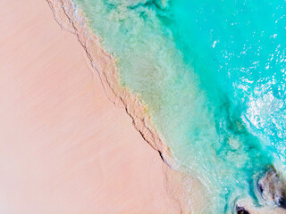 Aerial view of  beautiful tropical beach scene with soft white sand, and clear turquoise water with waves