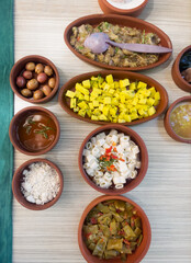 Stewed green pepper, baked eggplant, fried potatoes, pasta with sauce on the table. Homemade dishes. The concept of traditional Turkish cuisine. Vertical orientation.