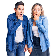 Couple of women wearing casual clothes looking fascinated with disbelief, surprise and amazed expression with hands on chin