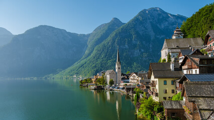Fototapeta premium Serene reflections of Hallstatt charming village by the tranquil lake at dawn