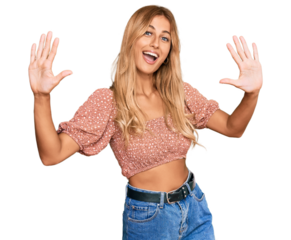 Beautiful blonde young woman wearing summer top showing and pointing up with fingers number ten while smiling confident and happy.