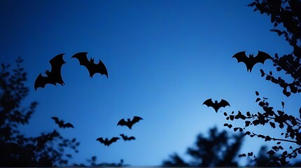 Fototapeta premium eerie silhouettes halloween night bats haunting blue sky framed shadowy branches