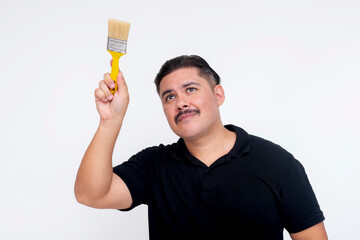 A studious middle aged man pretending to paint an imaginary wall with paint brush. For photo editing use. Isolated on a white background.