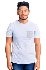 Fototapeta premium Handsome latin american young man wearing casual clothes with a happy and cool smile on face. lucky person.