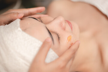 Beautician apply facial herbal cream and hand massage in spa, Face skin treatment body care relax claim with skincare baby face at wellness.