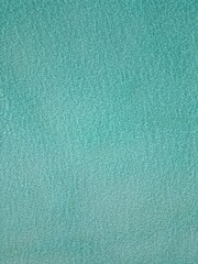 This image captures a breathtaking aerial view of a small, circular sandbank in the Maldives. 