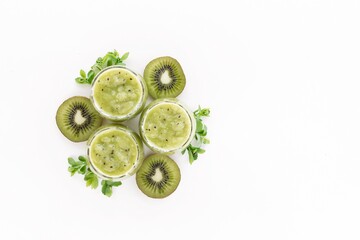Kiwi smoothie with fresh kiwi slices on white background. Vitamin food creative. Healthy food...