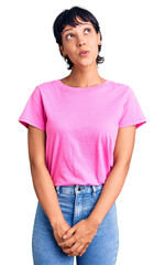 Young brunette woman with short hair wearing casual clothes smiling looking to the side and staring away thinking.