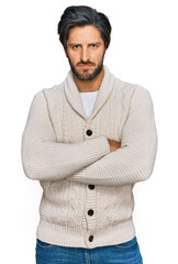 Young hispanic man wearing casual clothes skeptic and nervous, disapproving expression on face with...