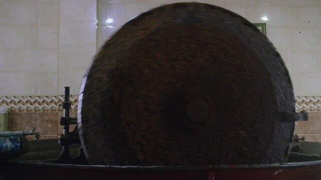 Olive mill machine at work Crushing olives to make oil traditional method.