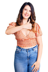 Fototapeta premium Beautiful young brunette woman wearing casual clothes doing happy thumbs up gesture with hand. approving expression looking at the camera showing success.