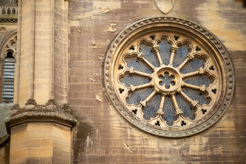 Ornate rose window on historic church exterior in daylight