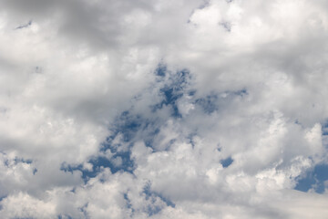 White clouds covering blue sky. Natural sky background with clouds.