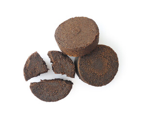 Used ground coffee tabs, waste from espresso machine isolated on white background. Natural body scrub ingredient, garden fertilizer.