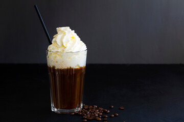 Hot viennese coffee with whipped cream on dark background. American glass of black coffee or espresso with coffee beans. Hot espresso coffee glass isolated on white table. copy space.