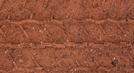 Close-up of car tire pattern on the ground,Close up of tire track or tire tread left behind in the mud or dirt.