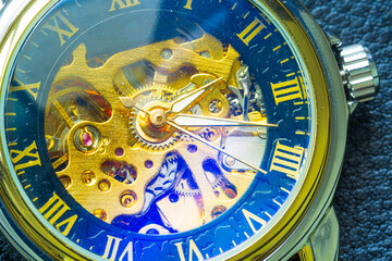 Clock mechanism, macro winding,Close-up of the internal mechanism of a vintage analog self-winding watch, focusing on the hands. Some internal reflections from dust speckles can be