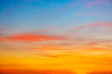 Colorful clouds and sky. Dusk and sunset. Evening clouds with orange, yellow, pink and red sunlight and amazing storm clouds in the dusk sky. 