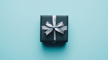 Elegant Black Gift Box with Silver Ribbon on Minimalistic Light Blue Background for Stylish Designs