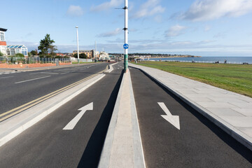 White arrows showing direction of travel painted on cycle paths in seaside location