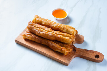 Youtiao or Yu Char Kway or cakwe is a long golden-brown deep-fried strip of wheat flour dough of Chinese origin. Perfect for recipe, article, catalogue, commercial, or any cooking content.