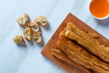 Youtiao or Yu Char Kway or cakwe is a long golden-brown deep-fried strip of wheat flour dough of Chinese origin. Perfect for recipe, article, catalogue, commercial, or any cooking content.