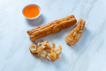 Youtiao or Yu Char Kway or cakwe is a long golden-brown deep-fried strip of wheat flour dough of Chinese origin. Perfect for recipe, article, catalogue, commercial, or any cooking content.