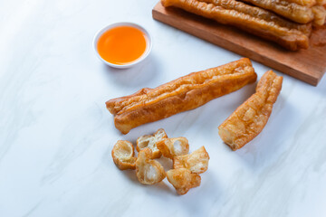 Youtiao or Yu Char Kway or cakwe is a long golden-brown deep-fried strip of wheat flour dough of Chinese origin. Perfect for recipe, article, catalogue, commercial, or any cooking content.