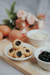 Description
Blueberry cheese cookies, eggs, butter and flour on a white table, cooking, baking. Top view