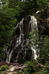 Mountain waterfall. Waterfall in the mountains in summer. Rocks