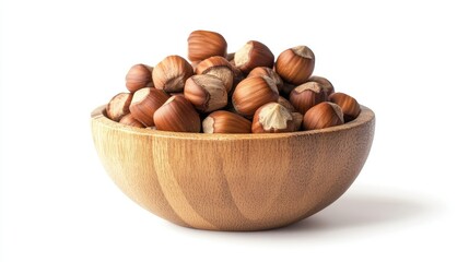 Obraz premium A handful of raw hazelnuts in a wooden bowl, showcasing healthy nutrition, isolated on a clean white background for a healthy food concept